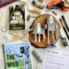 A table topped with books and other art supplies.